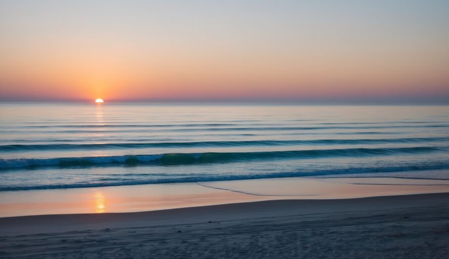 A peaceful beach scene with a serene ocean view and a calming sunset in Oceanside, CA