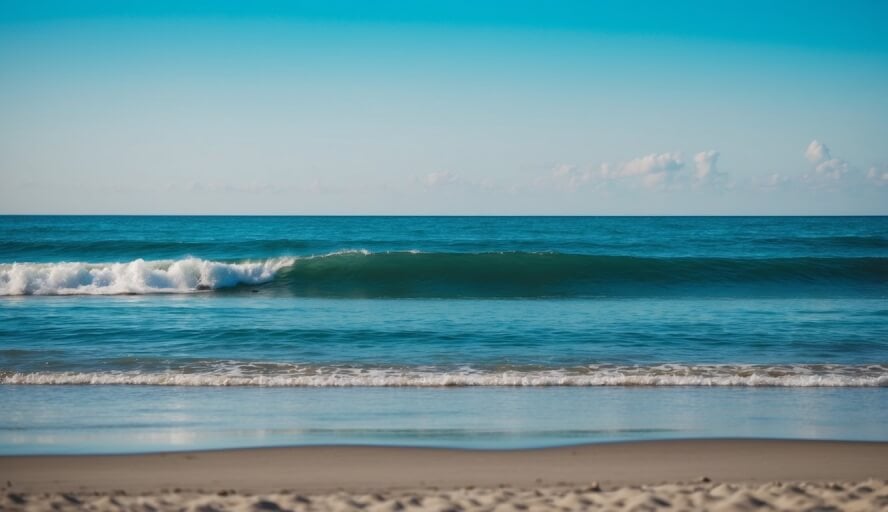 A tranquil beach setting with gentle waves, a clear blue sky, and a peaceful atmosphere